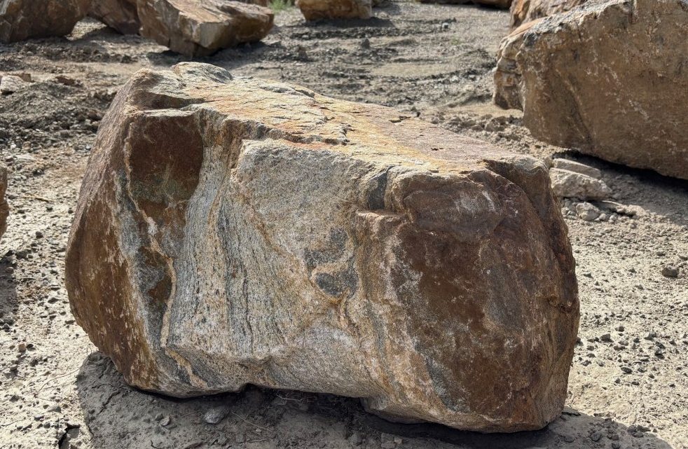 Colorado Sunset boulder. Warm tan, rust and grey natural granite.